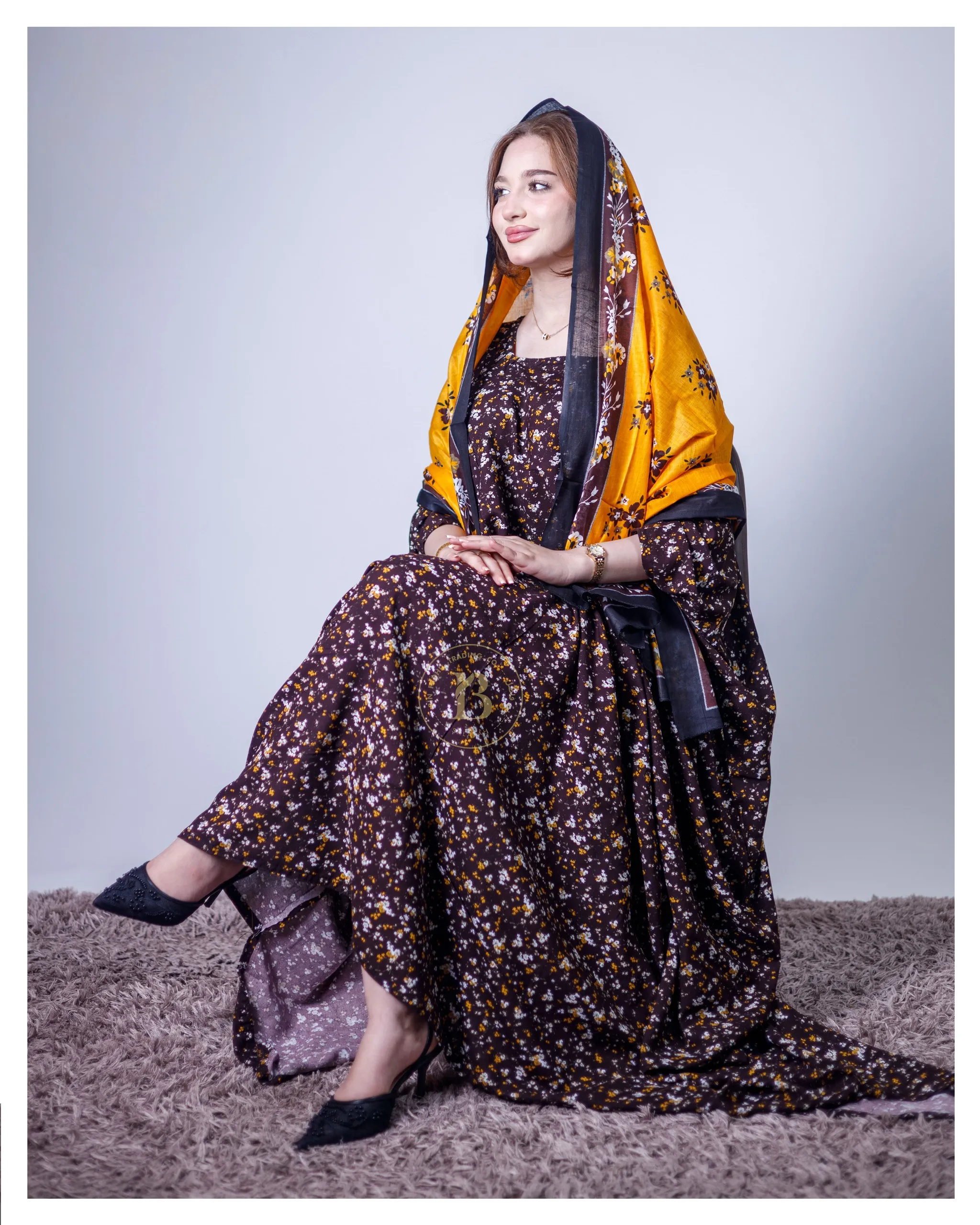 ثوب أرجواني اللون مصنوع من القطن، مزين بنقشة زهور جميلة، مع شيلة متناسقة، ومخيط على الطراز الظفاري