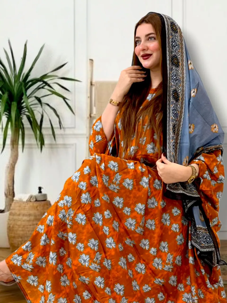 ثوب برتقالي اللون مصنوع من القطن مع تصميم زهور جميل مطبوع عليه وشيله مطابق مخيط على طراز ظفري